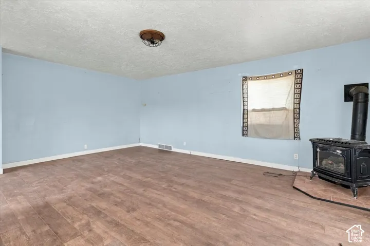 Wood-finish flooring, light blue walls, and a recessed window