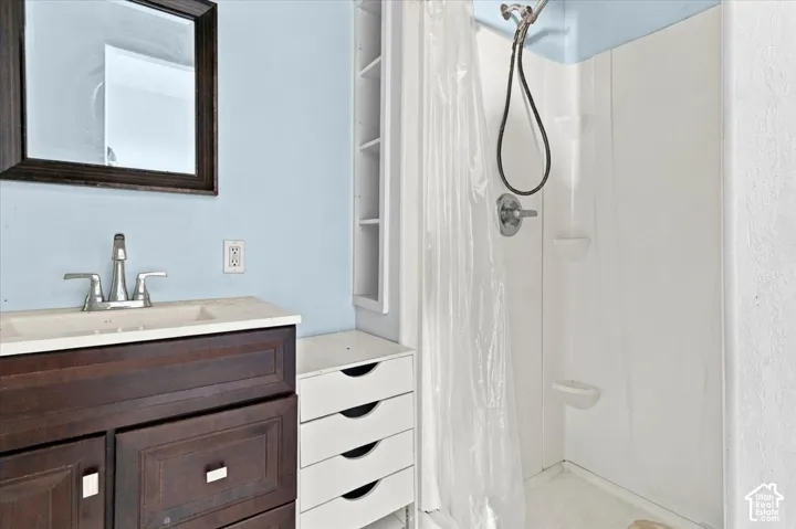 Dark wood-finish vanity with an integrated sink and chrome faucet