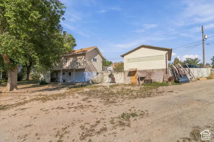 Two-story residence with siding exterior and an adjacent detached structure