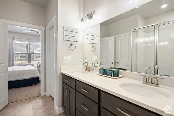 Dual vanity with undermount sinks, brushed nickel faucets, and dark wood-finish cabinetry