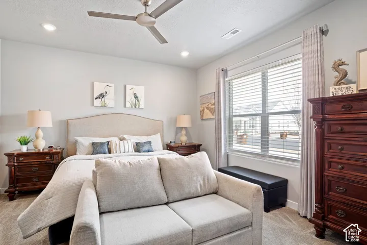 Recessed lighting, ceiling fan, window with blinds, and carpeted flooring