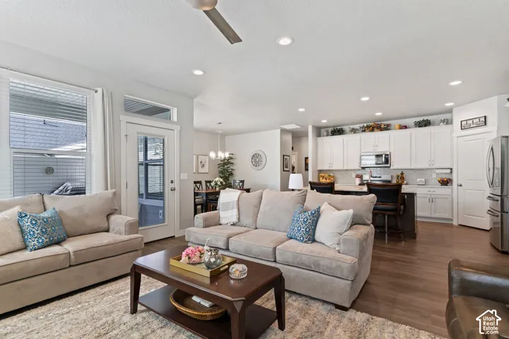 Open-concept living area featuring wood-finish flooring, recessed lighting, and a ceiling fan
