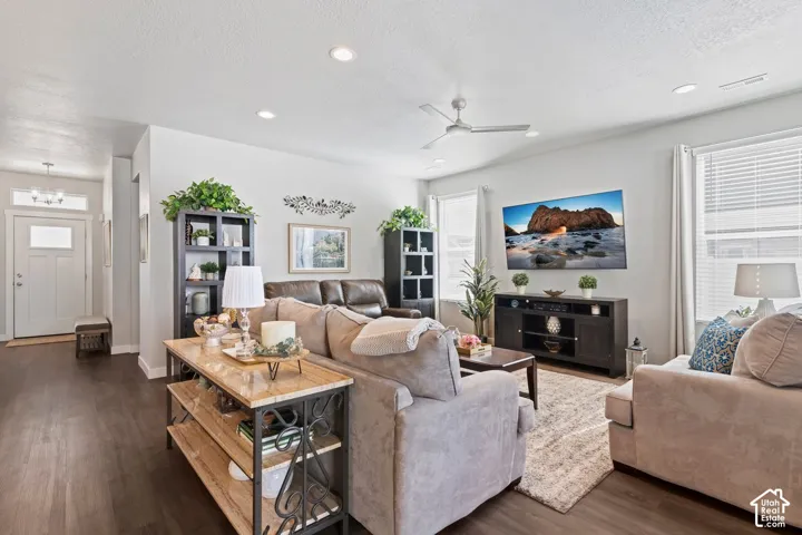 Recessed lighting, wood-finish flooring, ceiling fan, multiple windows with blinds, and a built-in shelving unit