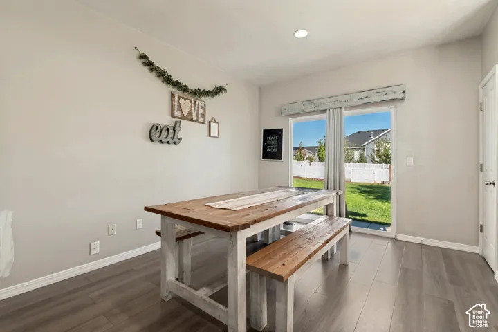 Sliding glass door, recessed lighting, wood-finish flooring, and white trim