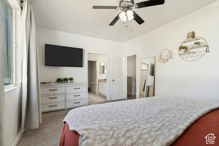 Recessed lighting, wall-mounted television, and a ceiling fan with integrated lighting
