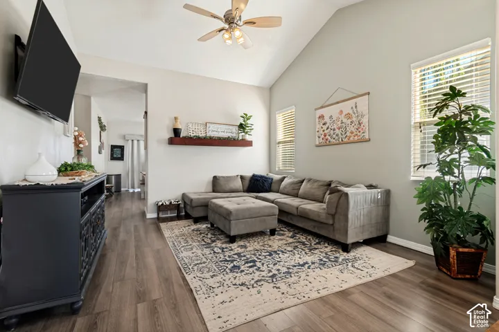 Wood-finish flooring throughout, complemented by a vaulted ceiling with a ceiling fan