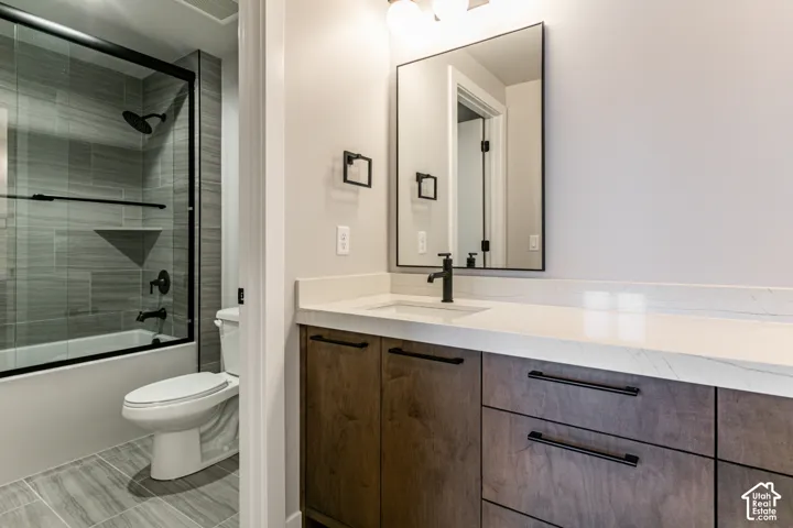 Wood-finish vanity with matte black hardware, white countertop, and rectangular mirror