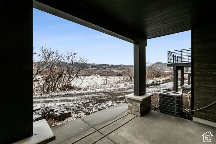 Covered concrete patio with stone-clad column bases