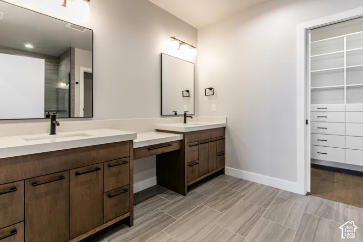 Dual wood-finish vanities with integrated sinks and white countertops