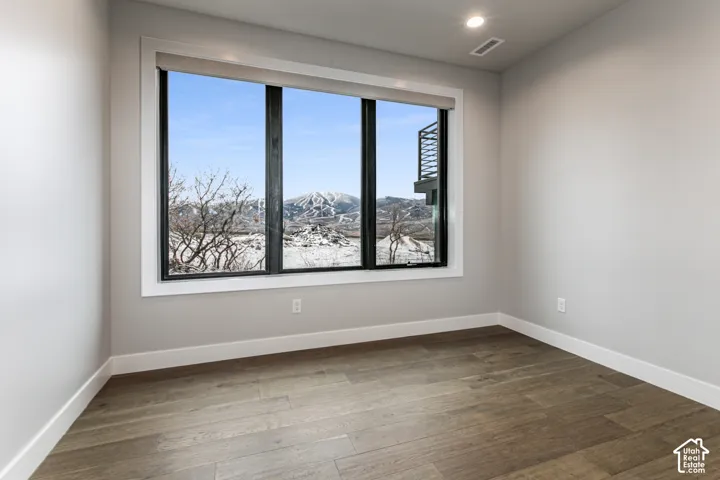 Expansive windows frame a mountain backdrop