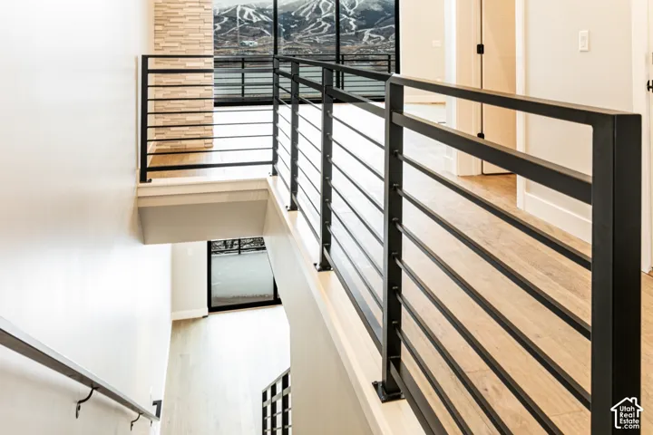 Modern black metal horizontal bar railing with wood-finish flooring
