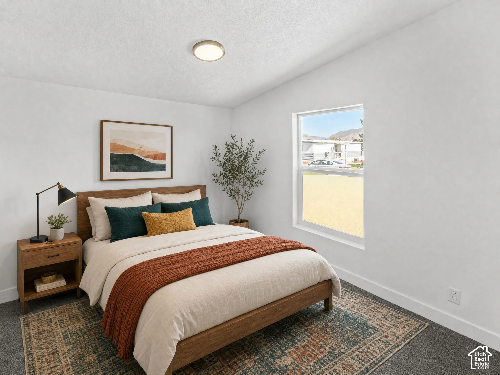 Recessed lighting, wood-finish bed frame, wood-finish nightstand with storage, white walls, and a window with natural light