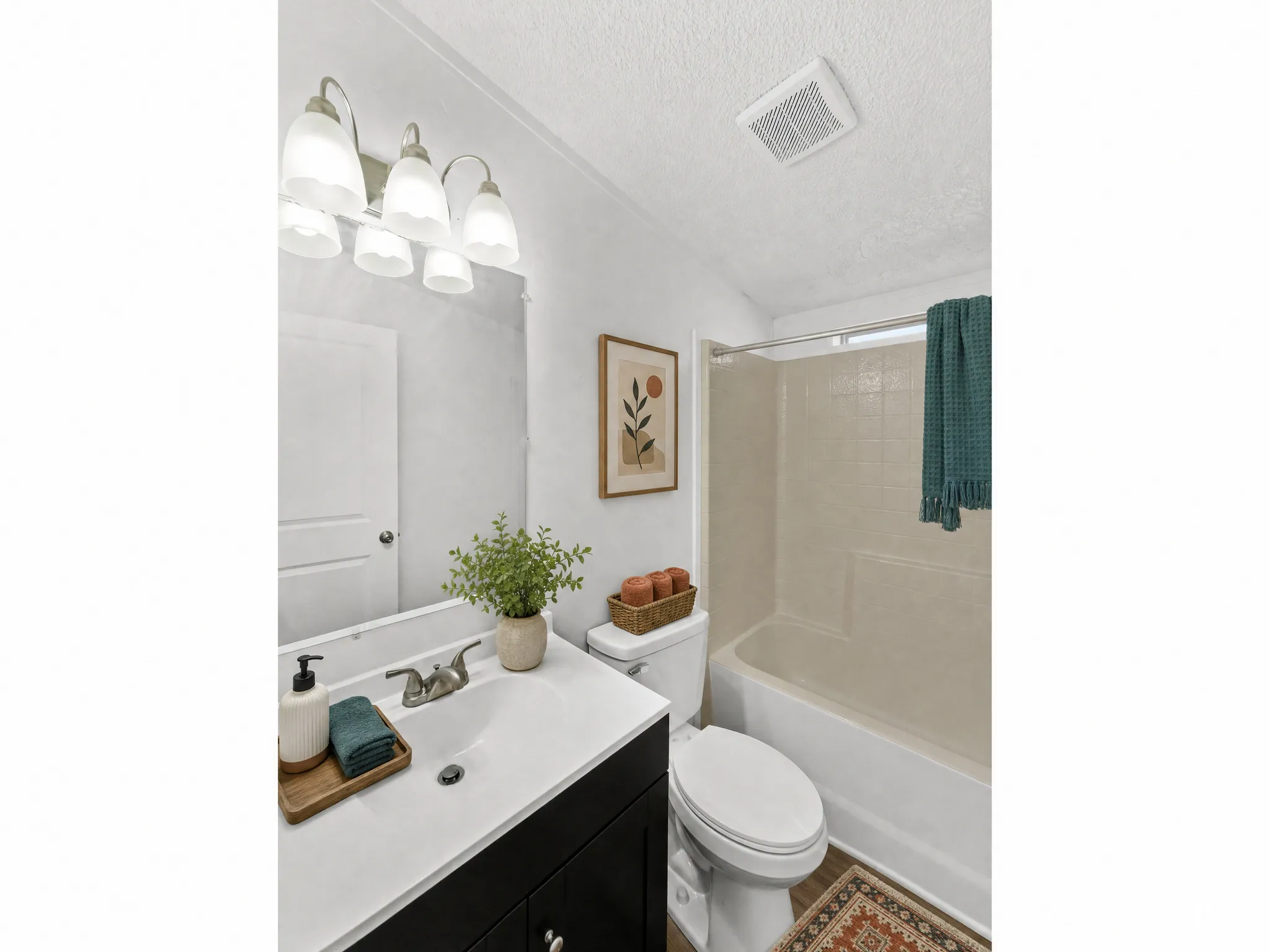 White vanity with integrated sink, brushed nickel faucet, and dark wood-finish cabinetry