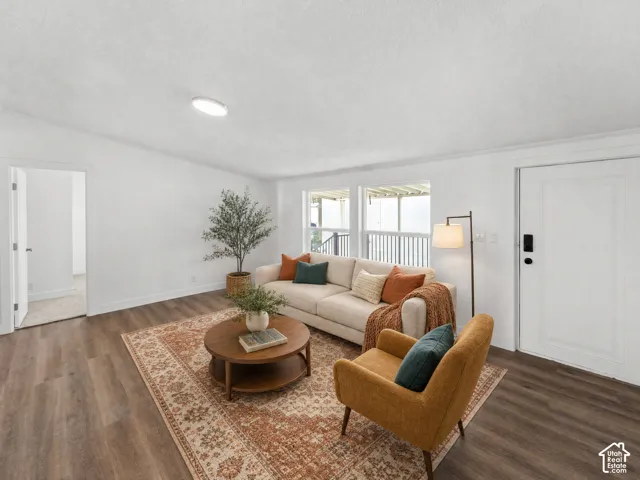 Recessed ceiling lighting, wood-finish flooring, white trim, and a white paneled door
