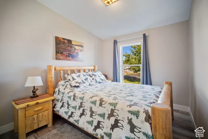 Vaulted ceiling, recessed lighting, double-hung window, wood-finish flooring, light-toned wall paint