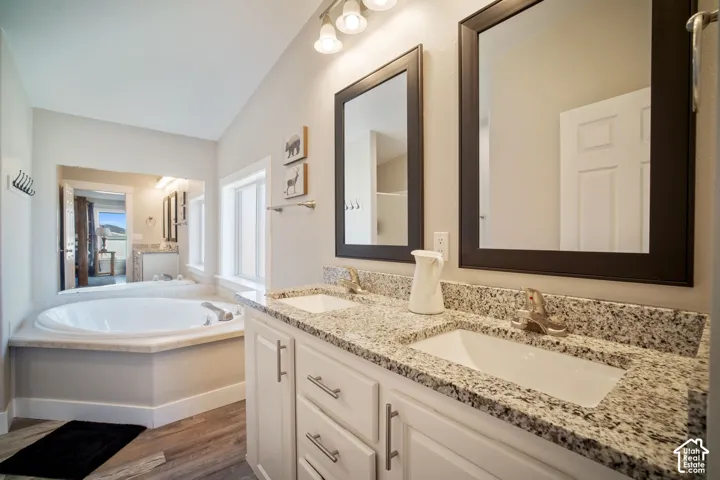 Dual vanity with granite countertops and undermount sinks, featuring individual framed mirrors