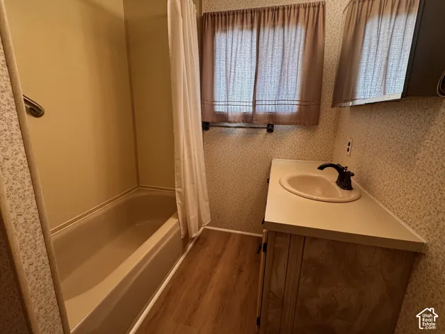 Built-in vanity with integrated sink, dark bronze faucet, and wood-finish cabinetry