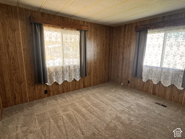 Wall paneling with wood-grain finish and textured ceiling