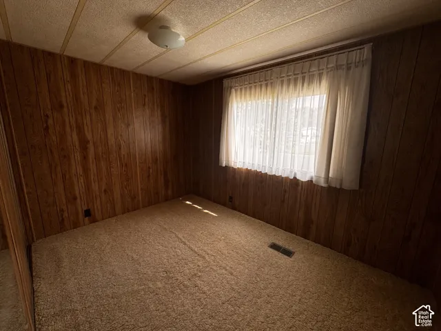 Textured paneling walls and a textured ceiling