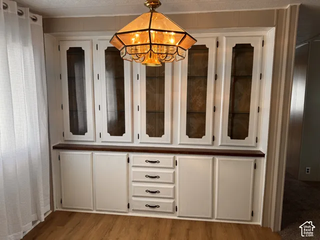 Built-in cabinetry with glass-front upper doors, lower cabinet storage, and a series of drawers