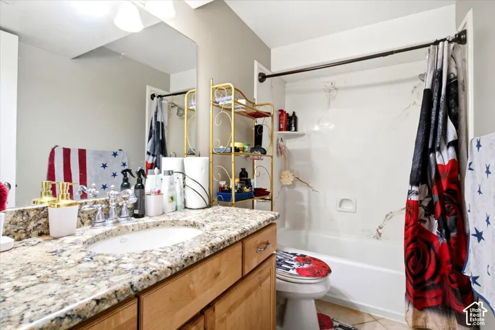 Vanity with a granite countertop and an undermount sink