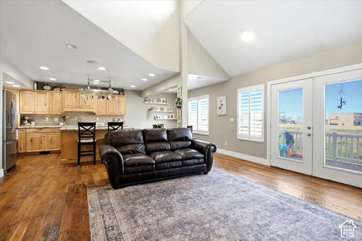 Vaulted ceilings and wood-finish flooring complement the open layout