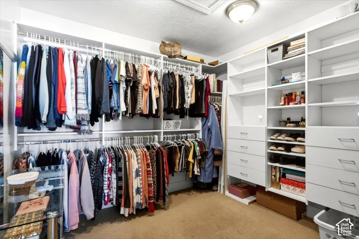 Custom closet system featuring white shelving and integrated drawers