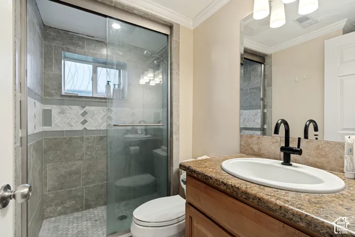 Glass-enclosed shower with tiled walls and a decorative band
