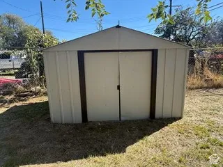 Outdoor storage shed featuring a pitched roof and double doors