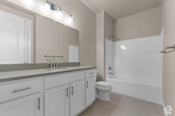 Vanity with stone countertop, undermount sink, and brushed nickel fixtures