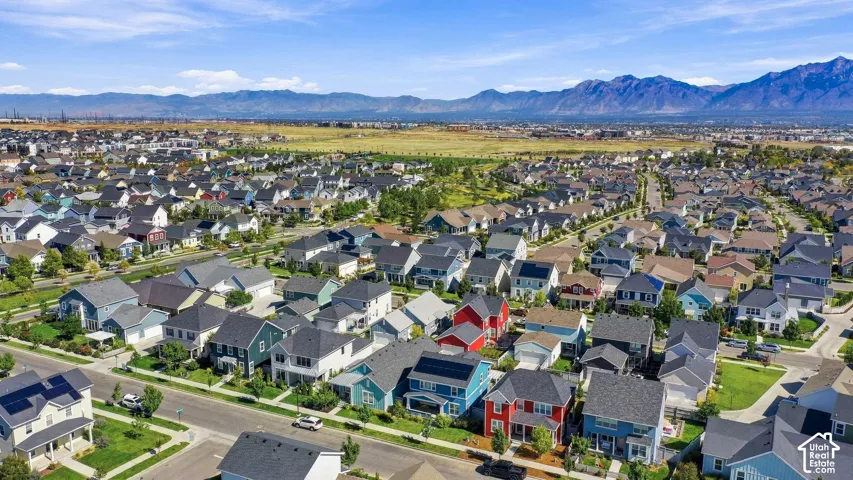 Expansive residential community featuring a variety of architectural styles, individual property landscaping, and mountain scenery