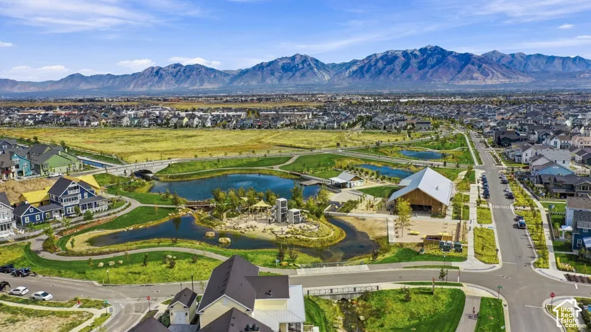 Large parkway with multiple water features, and a community gathering, drink facility near amphitheater.