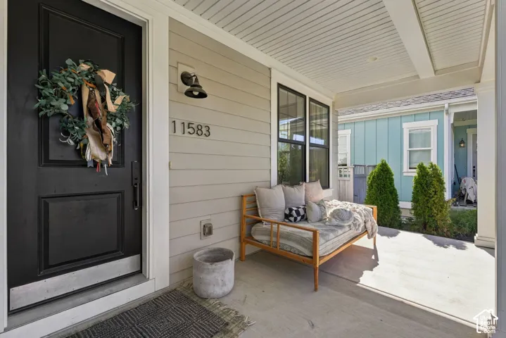 Covered front porch with shiplap ceiling, and generous seating & conversation area.