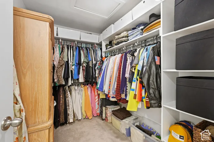 Primary Bedroom Suite Walk-in closet featuring built-in shelving, multiple hanging rods, and recessed lighting