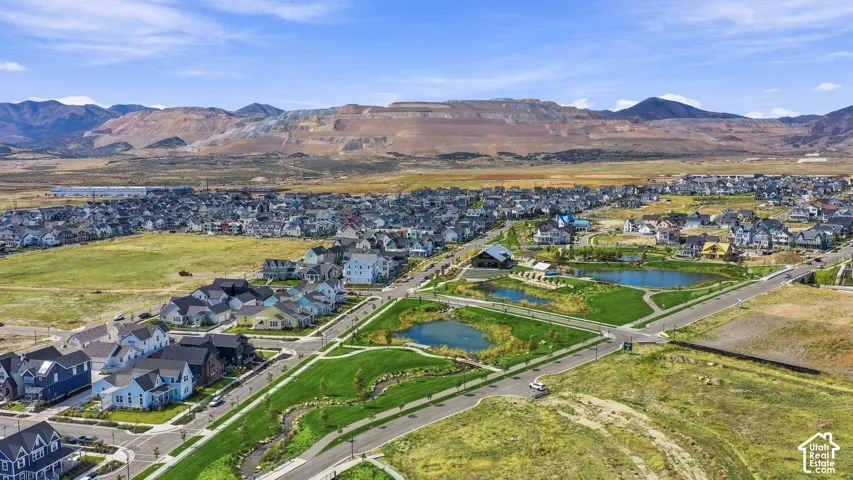 Expansive neighborhood view featuring water way, trails and amphitheater.