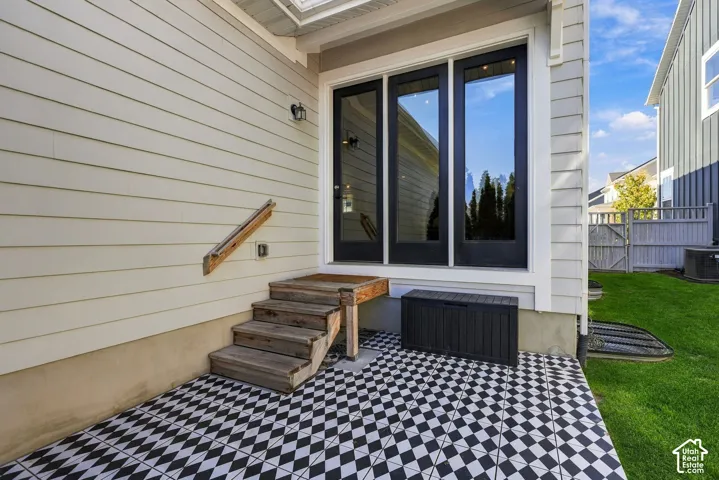 Backyard patio featuring black and white tile. Short step stack into the house