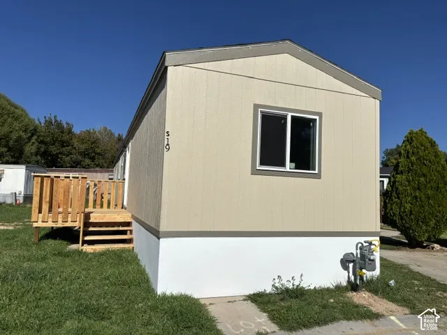 Beige vertical siding exterior with white trim