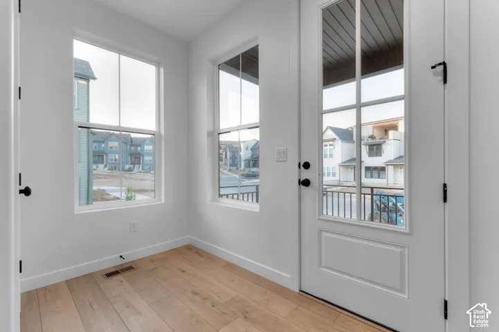 White interior walls with wood-finish flooring
