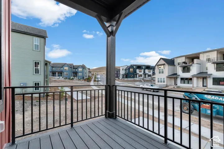 Covered balcony with composite decking and black metal railing