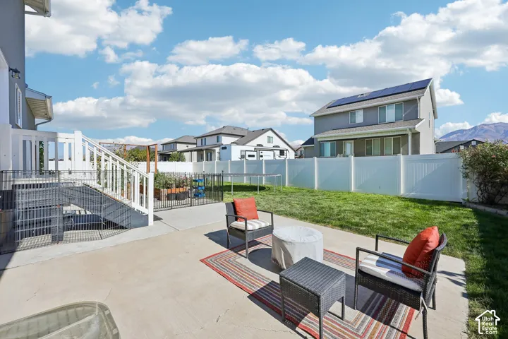 Concrete patio with white railing leading to the lower level