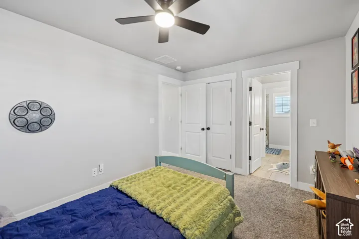 Recessed lighting, ceiling fan, white paneled doors, light grey wall paint, and carpet flooring