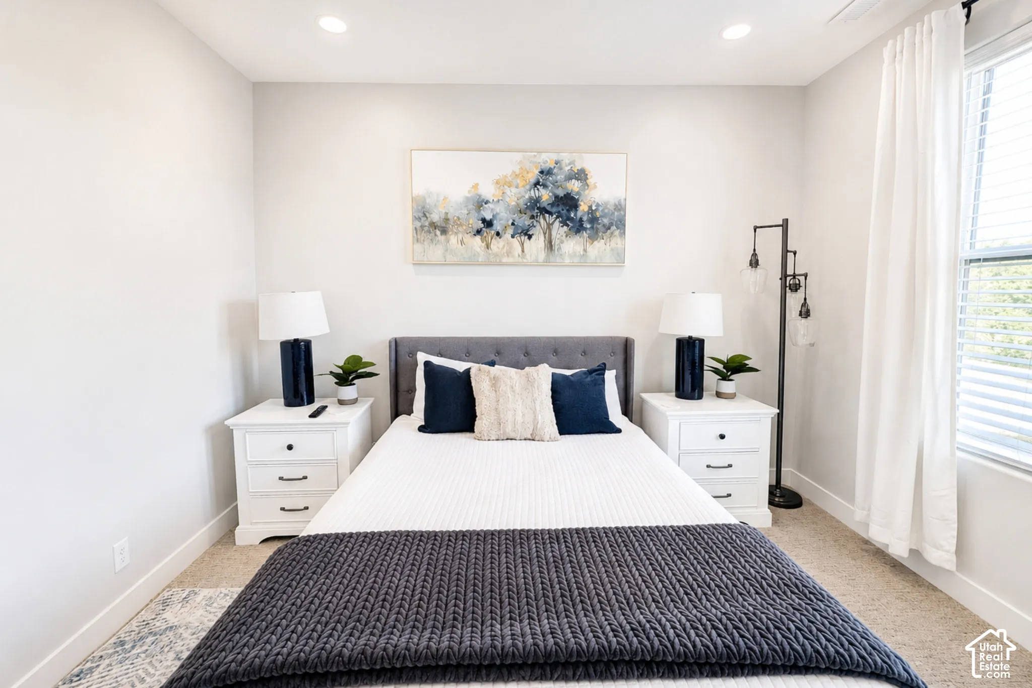 Wall-to-wall carpeting with recessed lighting and a window with blinds