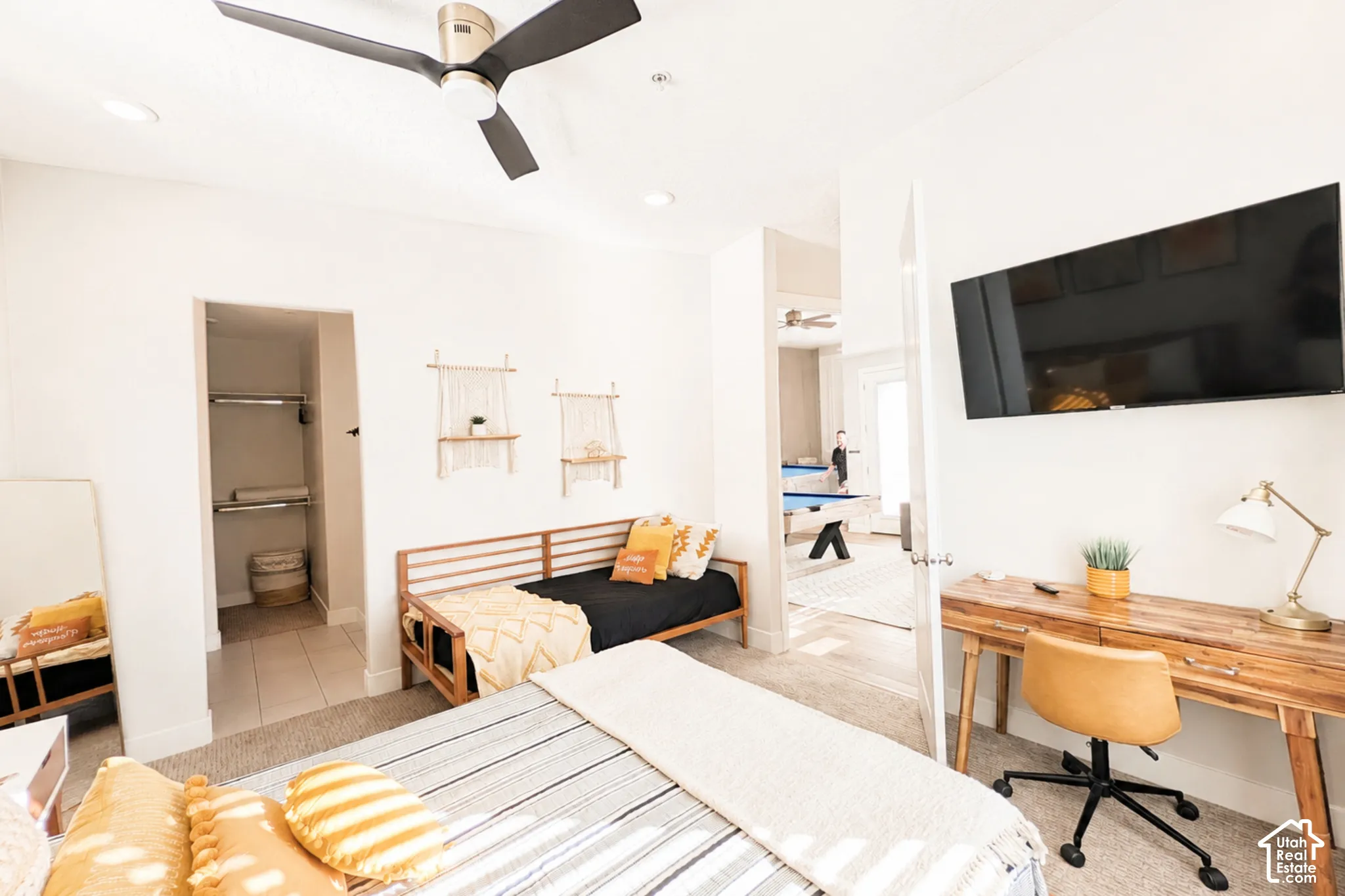 Carpeted bedroom with a ceiling fan, recessed lighting, and a closet featuring shelving and hanging rods