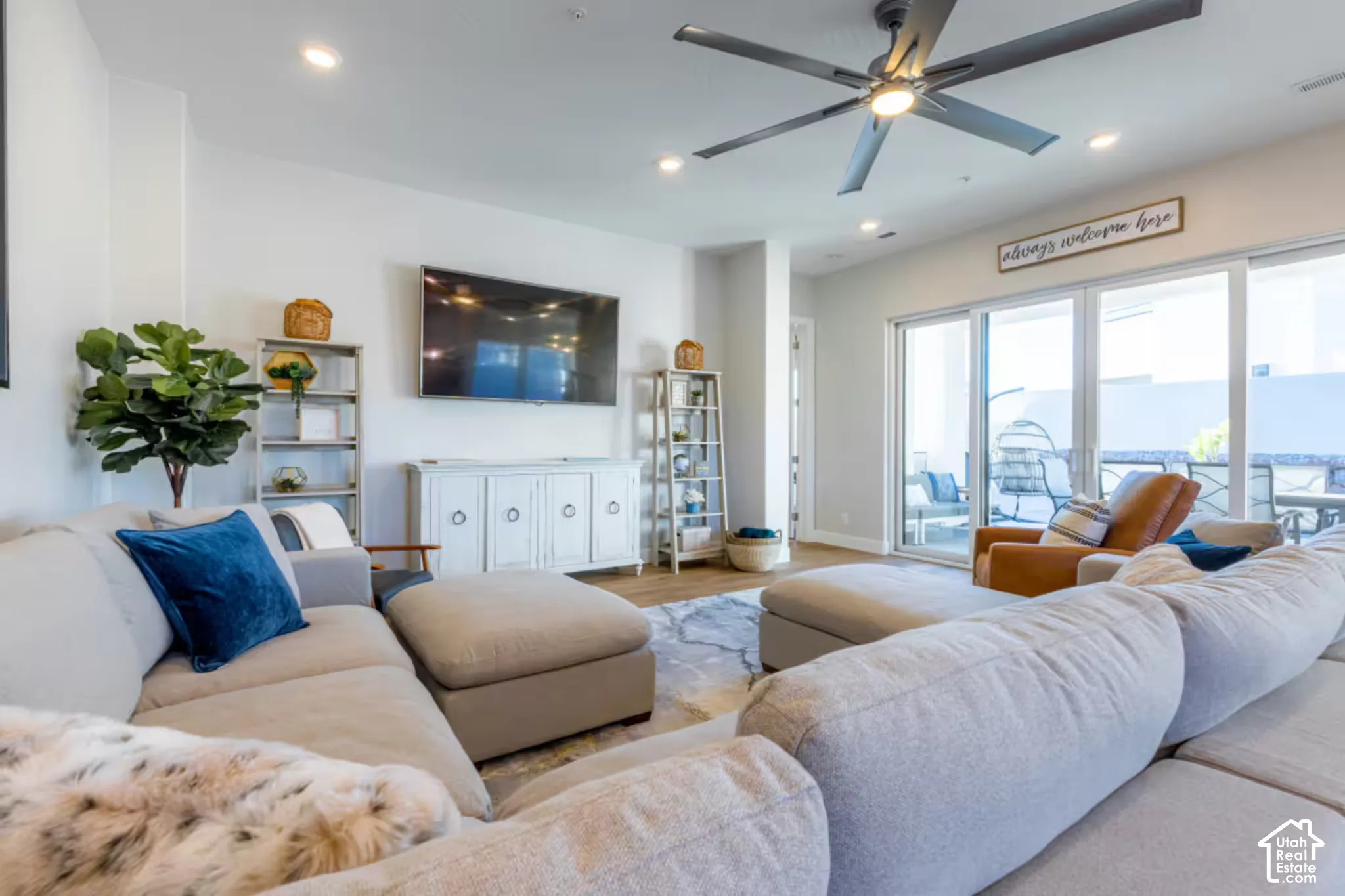 Recessed lighting, wood-finish flooring, a contemporary ceiling fan, and sliding glass doors leading to an outdoor patio