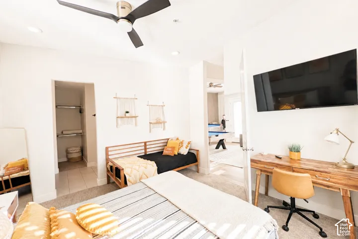 Carpeted bedroom with a ceiling fan, recessed lighting, and a closet featuring shelving and hanging rods