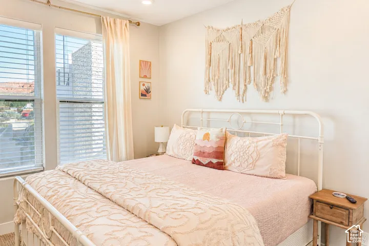 Recessed lighting, two large windows with blinds, and light-toned walls