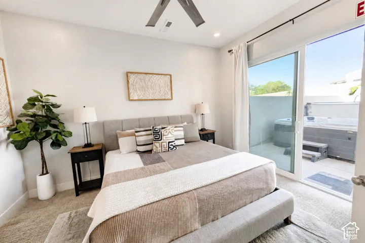 Sliding glass doors provide access to an outdoor patio with a built-in hot tub