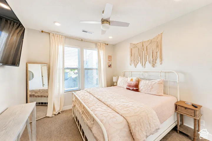 Recessed lighting, ceiling fan, carpeting, and double windows with blinds