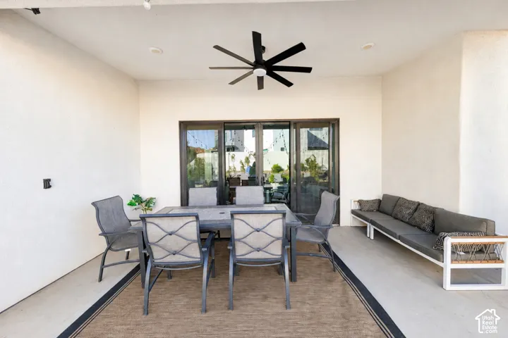Covered patio with a black ceiling fan, recessed lighting, and sliding glass doors