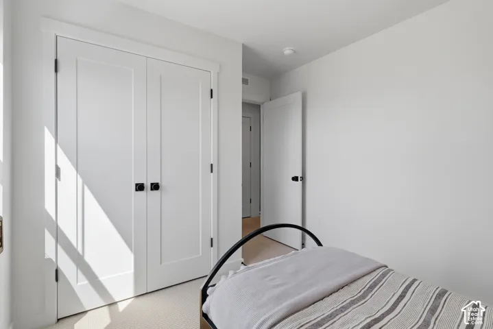 White walls, recessed ceiling lighting, and panel doors with matte black hardware